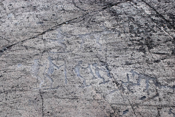 istock Petroglyph Primitive drawings on stones. Ancient art by prehistoric humans. 1193531649