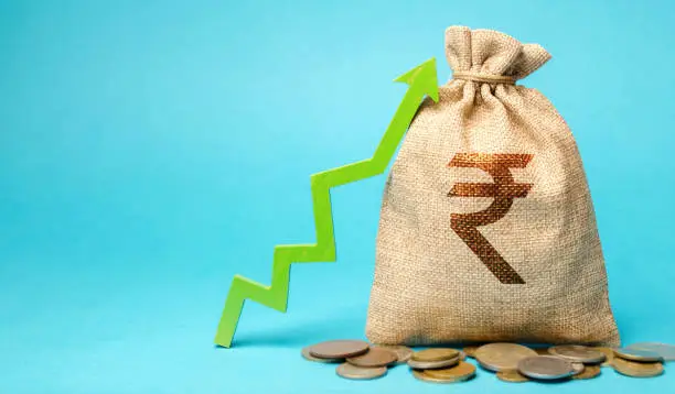 Photo of Money bag with coins and up arrow. The concept of a successful business. Increase profits and capital. Budget and Revenue Growth. Rupee, rupiah