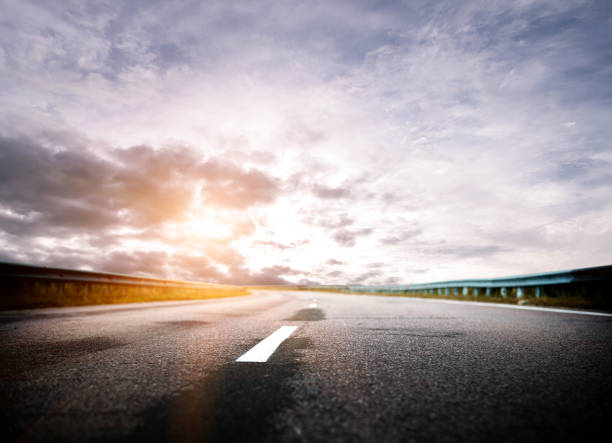 istock Summer road, sky, sun and clouds 1193533846