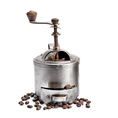 Vintage hand manual coffee grinder coffee grinder and coffee beans isolated on white background. Retro kitchen utensils.