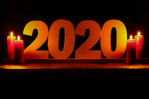 istock 2020 - Plywood figures are illuminated by burning candles 1193536103