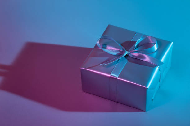 istock Gift box illuminated with colorful lights 1193537547