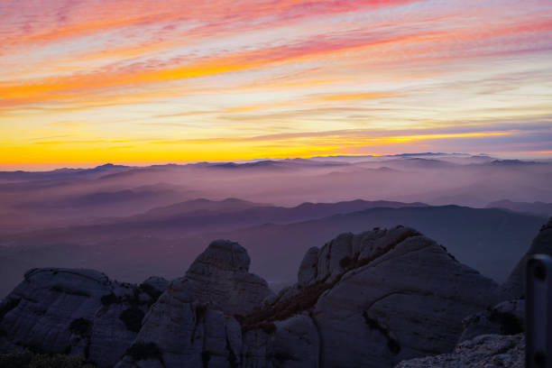 Montserrat in Barcelona, an amazing sunset with mist between the mountains looking towards west.