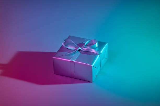 istock Gift box illuminated with colorful lights 1193537742