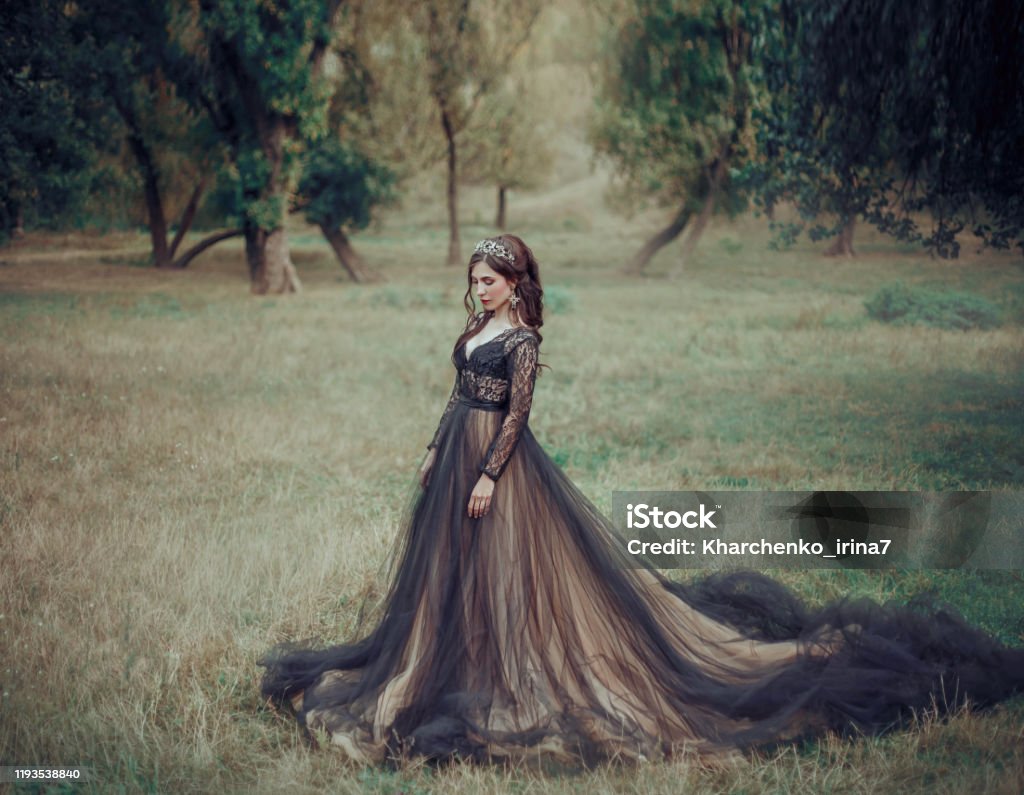 Glamorous Fashion Woman In Luxurious Dress Beige Long Train Backdrop Summer Nature Gothic Fantasy Beauty Girl Attractive Sexy Dark Queen Graduate Image For Celebration Prom Ball Stock Photo -