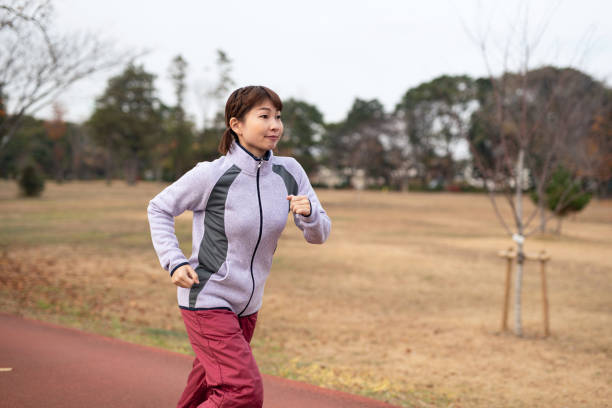 istock Woman running in Autumn park 1193539073