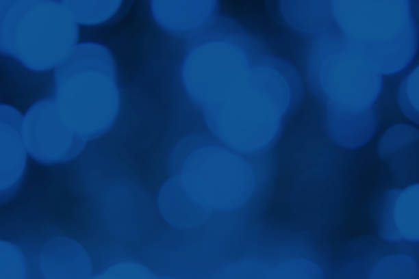 dark blurred lights classic blue background. abstract bokeh with soft light. shiny festive texture - royal blue imagens e fotografias de stock