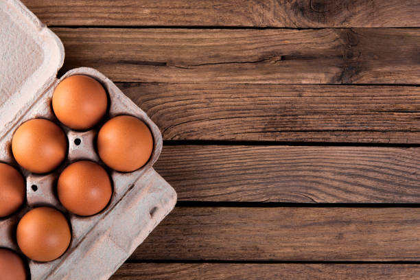 istock raw chicken eggs in egg box on wooden background 1193542254
