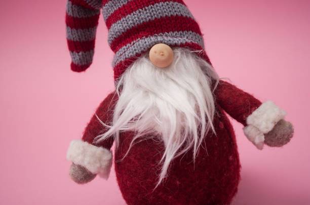 istock christmas gnome on pink background 1193543408