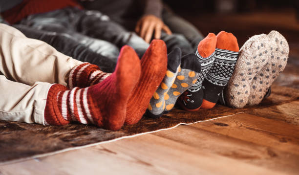 christmas socks at home christmas socks at home heat home interior comfortable human foot stock pictures, royalty-free photos & images