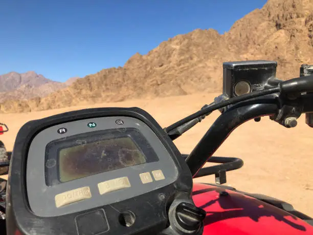 Elements of a motobike for tourist adventures in the desert. Dashboard and steering wheel gas and brakes.
