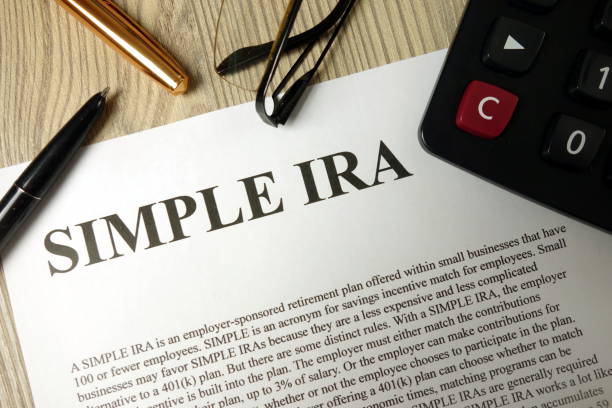 istock Simple ira document with pen calculator and glasses 1193546859