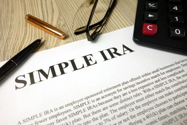 istock Simple ira document with pen calculator and glasses 1193546926
