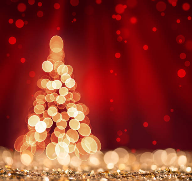 Red light and Christmas Tree on defocused sparkles background stock photo