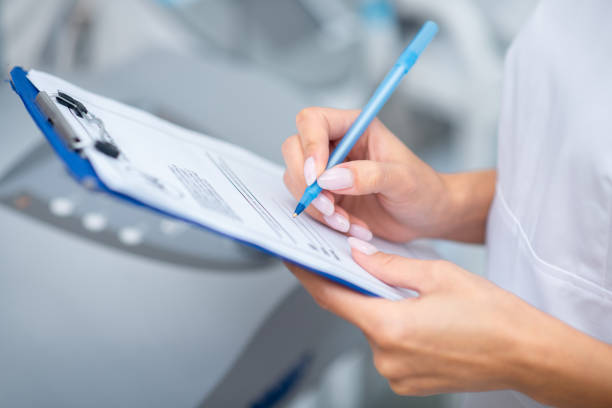 istock Close up of woman holding pen while making notes after seeing client 1193548521