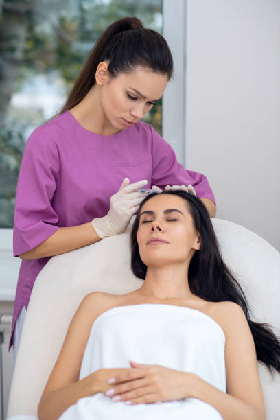 istock Businesswoman closing eyes while having mesotherapy injection 1193548653