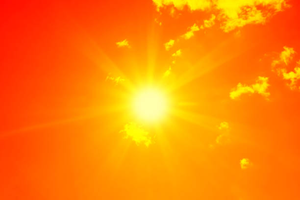istock Bright sun with beautiful beams in the sky with clouds (toned in red) 1193549887