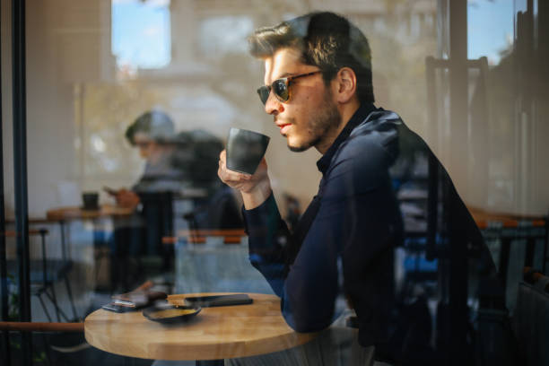 istock Business man drinking coffee in a cafe 1193550047