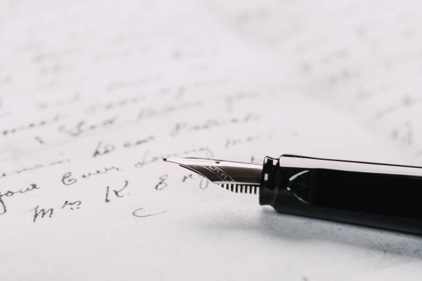 istock fountain pen on paper with ink text closeup 1193551523
