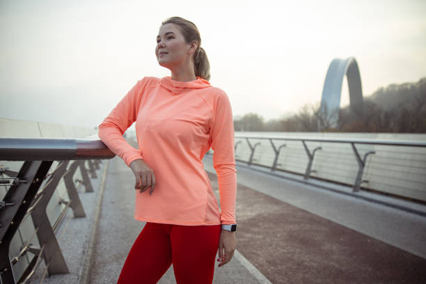 istock Charming sporty lady standing on the bridge 1193552816