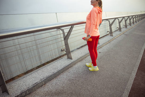 istock Charming sporty lady standing on the bridge 1193552848