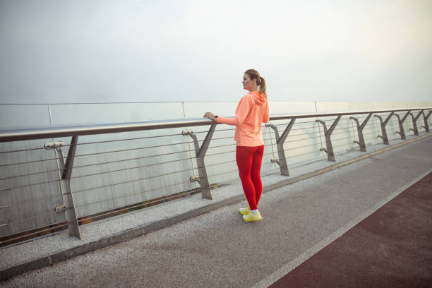 istock Beautiful sporty lady standing on the bridge 1193552861