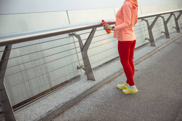 istock Sporty young lady standing on the bridge 1193552871