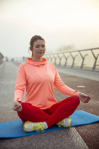istock Serene young woman meditating in lotus position 1193553036