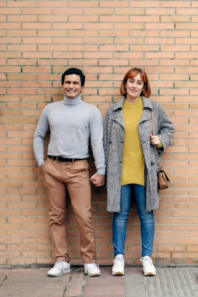 istock Happy couple smiling and looking at camera 1193553404