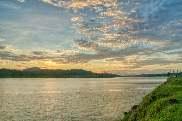 Beautiful Sunset Over the Chagres River and Panama Canal in Soberania National Park of Gamboa, Panama in Central America Beautiful Sunset Over the Chagres River and Panama Canal in Soberanía National Park of Gamboa, Panama. soberania national park stock pictures, royalty-free photos & images