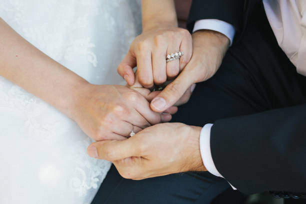 istock bride and groom holding hands 1193554916