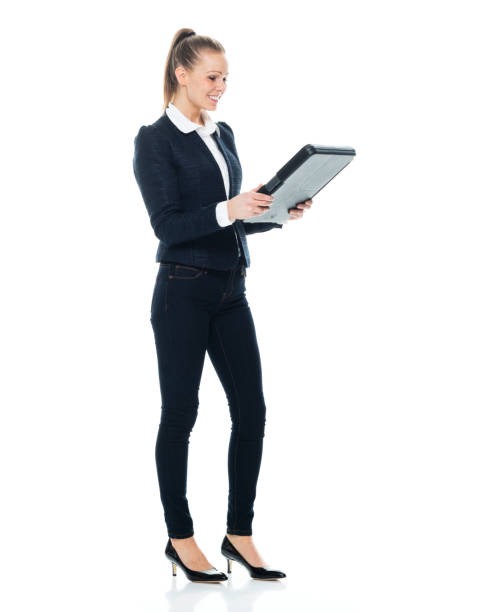 istock Full length / side view / profile view / front view / looking at camera / one person of 20-29 years old adult beautiful brown hair / ponytail caucasian female / young women business person / businesswoman standing with hand by side 1193555112