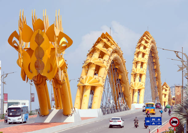 Dragon Bridge Da Nang, Central Vietnam.  Da Nang Dragon Bridge, a stylised yellow steel bridge replica of a mythological dragon, crossing the Han River at Le Dinh Duong/Bach Dang traffic circle, the shortest road link from Da Nang Airport to Da Nang city,My Khe Beach and Non Nuoc Beach