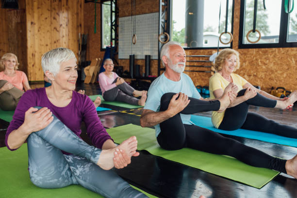 istock Seniors stretching legs on a yoga class 1193556277