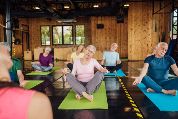 istock Seniors doing yoga in a group 1193556280