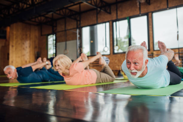 istock Seniors doing yoga and having fun together 1193556286