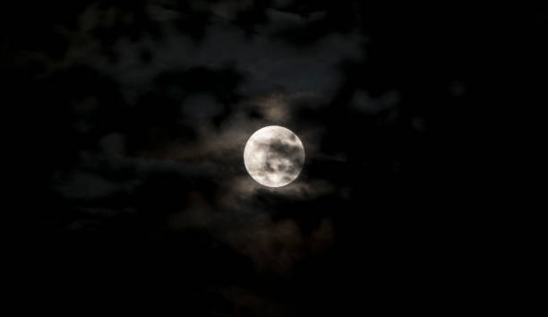 istock Full moon in dark sky with clouds 1193557350