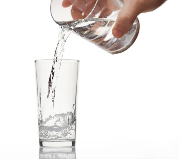 istock pouring sparkling water in a glass on white background, isolated object 1193560963