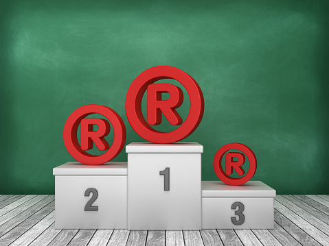 Podium with Trademark Symbol on Chalkboard Background - 3D Rendering