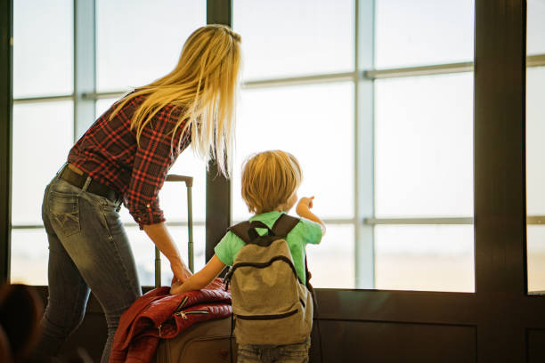 istock MOther and son on airport 1193562510