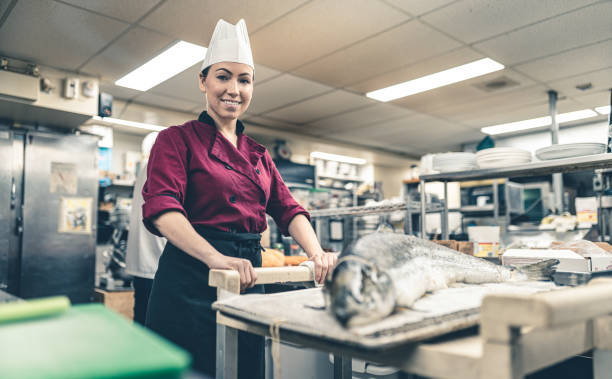 istock Female Chef working in industrial kitchen 1193563475