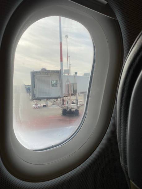 istock Airport gangway seen through cloudy airplane window 1193563603
