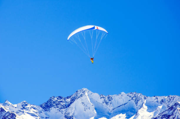 istock Skier and paraglider in Alps 1193563764