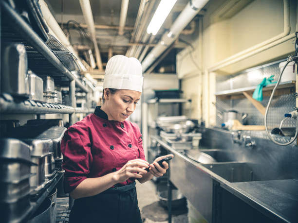 istock Female Chef with mobile phone 1193563891