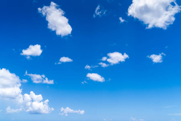 istock White fluffy clouds in the blue sky at caribbean ocean 1193564521