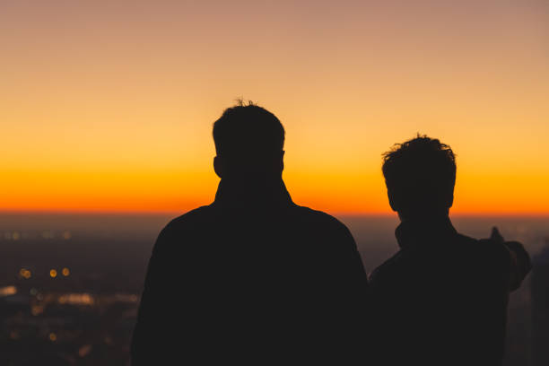 istock silhouette of two people at sunset 1193564781