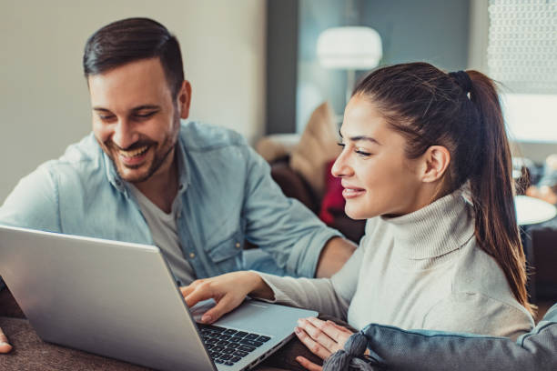 istock Young couple at home using laptop 1193565187
