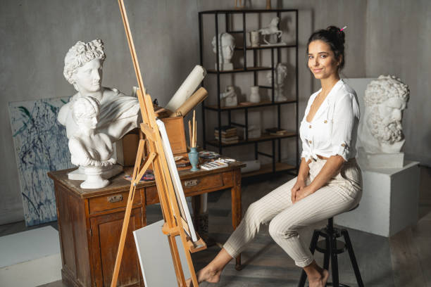 istock Happy nice lady posing for camera in art room 1193565387