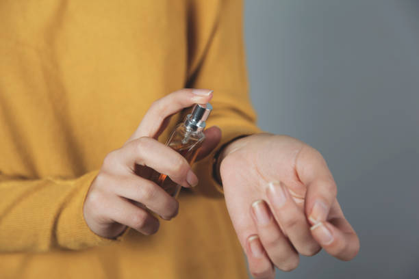 istock woman hand bottle of perfume 1193566319
