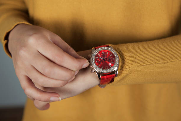 istock woman hand holding red watch 1193566344